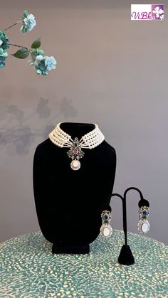 Indulge in luxury with our elegant Pearl 5-Line Choker set. Adorned with ruby emeralds, sapphires, and ADs, this pendant and earring set adds a sophisticated touch to any outfit. Its versatility allows it to be worn with various ensembles, exuding a regal charm. Elevate your style with this exclusive set. Elegant Festive Multi-stone Jewelry Sets, Elegant Multicolor Ruby Jewelry, Elegant Multi-stone Jewelry Sets For Celebration, Elegant Multi-stone Emerald Jewelry, Multicolor Ruby Jewelry For Formal Occasions, Elegant Multi-stone Jewelry Sets For Gifts, Elegant Multi-stone Jewelry Sets As A Gift, Elegant Multi-stone Emerald Necklace For Formal Occasions, Elegant Green Ruby Jewelry