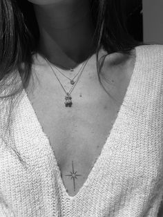 a woman with a cross tattoo on her chest