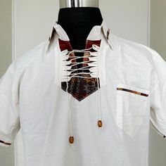 MADE IN MEXICO SELLING ONLY BY COLOR. We've received a large quantity of guayaberas imported from Mexico.The embroidery pattern might be different from the picture.But you will receive a genuinely unique, beautiful, detailed guayabera. For: Men Size: Large ( Chest: 40-42"; Length: 28-29") Color: off-white Details: 100% Linen Classic Fit Short Sleeve 1 Front Pocket Machine Wash - please wash before wearing Washing Instructions: One thing to remember when washing a guayabera shirt is to wash it wi Summer T-shirt With Placket And Short Sleeves, White Cotton T-shirt With Henley Neckline, White Camp Shirt With Camp Collar, White Camp Shirt With Pockets And Camp Collar, White Short Sleeve Camp Shirt With Placket, White Short Sleeve Shirt With Camp Collar And Pockets, White Short Sleeve Shirt With Pockets And Camp Collar, White Cotton Short Sleeve Shirt With Johnny Collar, Cotton Short Sleeve Shirt With Johnny Collar For Vacation