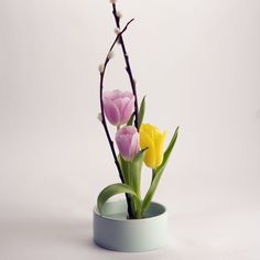 a white vase with some flowers in it