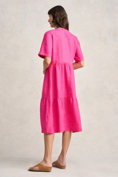 This striking Hot Pink dress will be your next warm weather showstopper! Midi-length with a comfortable relaxed fit, this 100% French linen dress features a flattering cutaway neckline and short sleeve with beautiful embroidered cross stitch detail. It’s stylish, comfortable and feminine. Embroidered Cross, Hot Pink Dress, Hot Pink Dresses, Spring Wear, Scarf Poncho, Work Wear Women, French Linen, Wearing Clothes, Knitwear Cardigan