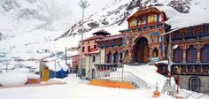 the building is covered in snow and has many windows on each side that are decorated with colorful designs