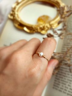 ✨ Tiny Freshwater Pearl Ring with choices of 14K Gold Filled, Rose Gold Filled or 925 Sterling Silver, June Birthstone Gift 💙 Dainty stacking ring with one small pearl. Make a very cute pinky ring. *Pearl Size: 4 mm *Ring Band: 0.8 mm ✨ Pearl symbolizes modesty, innocence & purity. Pearl is believed to offer protection, as well as attract good luck & wealth ✨ * Handmade in your ring size with 14K gold-filled or Sterling Silver wire and Natural Freshwater Pearl. * 14K gold-filled wire is known f Delicate Tiny Jewelry For Anniversary, Elegant 14k Gold-filled Promise Ring, Delicate Pearl Birthstone Ring, Elegant Adjustable 14k Gold Filled Rings, Rose Gold 14k Gold Filled Rings For Anniversary, Rose Gold 14k Gold-filled Rings For Anniversary, Rose Gold 14k Gold Filled Rings For Wedding, 14k Gold Filled Round Band Wedding Rings, Rose Gold 14k Gold-filled Wedding Rings