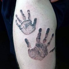 a man with a tattoo on his arm that has two hand prints on it