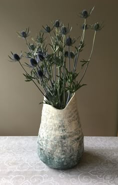 a vase filled with flowers on top of a table