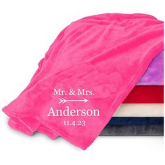 the personalized towels are stacked on top of each other in pink, purple and blue