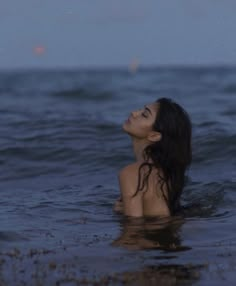 a woman floating in the ocean at night