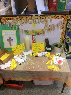 a bulletin board with flowers and candles on it in front of a sign that says collection amd