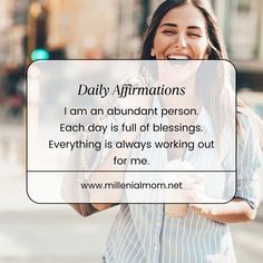 a woman smiling and holding a coffee mug with the words daily affirmitions i am an abundant person each day is full of blessing