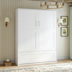 a large white cabinet sitting in the middle of a living room next to a window