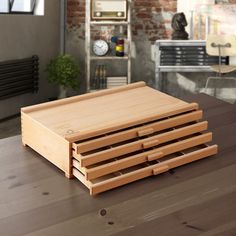 a stack of drawers sitting on top of a wooden table