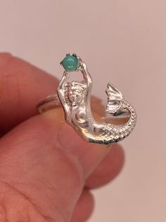 Sterling Art Nouveau mermaid ring is 17.5mm top to bottom by 12.2mm wide with 2.5mm turquoise stone. Shank is 2 mm wide at top, tapering to 1.6mm at bottom. Size 7.25 and sizeable. 2.5g Also available in 10k, 14k, 18k yellow, white, and pink gold. inquire for prices. Mermaid Rings, Art Nouveau Mermaid, Jewelry Closet, Mermaid Ring, Mermaid Core, Grade 8, Recycled Metal, Pearl Ring, Pearl Pendant