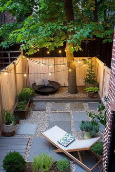 Cozy backyard with string lights, lush plants, wooden fencing, a modern lounge chair, and a circular seating area around a tree. Small Backyard With Garden, City Alleyway, Backyard With Garden, Tree Landscaping