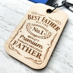 a wooden keychain with the words, best father and no1 on it