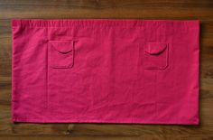 a pink bag sitting on top of a wooden floor