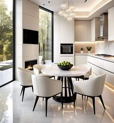 a dining room table with white chairs and a bowl of fruit on top of it