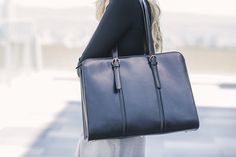 This functional and elegant leather laptop bag is a reliable companion to a woman on-the-go, whether she's working, traveling, or commuting. Workwear Tote Bag With Luggage Sleeve, Chic Black Laptop Bag For Work, Workwear Satchel Laptop Bag, Chic Business Satchel With Laptop Sleeve, Versatile Rectangular Briefcase For Work, Workwear Satchel Tote With Luggage Sleeve, Classic Laptop Bag For Business Trips, Workwear Bag With Laptop Sleeve And Double Handle, Sleek Travel Bags With Top Carry Handle