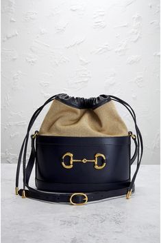 Find GUCCI Horsebit 1955 Bucket Bag on Editorialist. This Gucci Horsebit 1955 Bucket Bag is crafted from calf leather. It features gold-tone hardware, a drawstring closure, one main compartment with a single slip pocket, and an adjustable shoulder strap with a 19 to 22 inch drop. It measures approximately 9 inches wide, 10 inches high, and 5 inches deep. The bag includes an original dust bag and care booklet. The bag shows signs of moderate to significant wear, including scratches and rubbing on Designer Gucci Bucket Bag With Removable Pouch, Chic Gucci Bucket Bag With Removable Pouch, Gucci Bucket Bag With Gold-tone Hardware, Gucci Bucket Bag With Gold-tone Hardware For Travel, Gucci Chic Bucket Bag With Gold-tone Hardware, Chic Gucci Bucket Bag With Gold-tone Hardware, Designer Gucci Bucket Bag With Detachable Strap, Gucci Bucket Bag With Removable Pouch, Gucci Luxury Bucket Bag With Removable Pouch