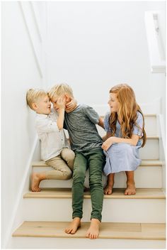 three children sitting on the stairs with their mouths open