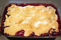 an uncooked berry pie in a glass dish