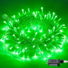 green christmas lights with white stars on the top and one light plugged into an extension cord