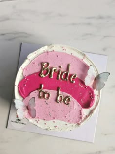 there is a cake that says bride to be on the top and butterflies around it