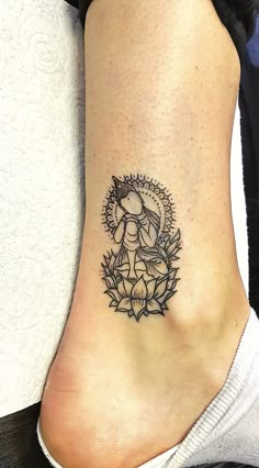 a woman's foot with a small tattoo on the side of her leg,