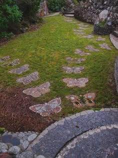 a stone path in the middle of a grassy area