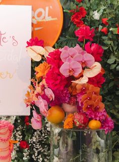 there is a sign that says celebrate mother's day next to some flowers and fruit