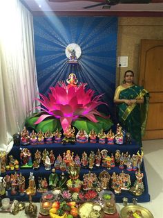 a large display of small buddha figurines in front of a window