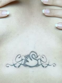 a woman's chest with an intricate tattoo design on her left side ribcage