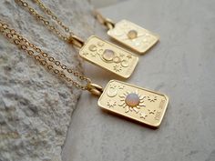 We're so excited to introduce my new line of high quality, anti-tarnish, waterproof jewelry. Thanks to our special plating technique, this celestial beauty is built to last, both pendant and chain are anti tarnish and waterproof. Crafted with hypoallergenic 18k gold stainless steel, it's lead and nickel free and safe and comfortable for sensitive skin. Your choice of pendants feature three of my favorite Major Arcana cards and a sweet little faux opal cabochon for an added touch of mystery. Choo Mystical Gold Charm Necklace Gift, Celestial Rectangular Pendant Jewelry Gift, Celestial Style Rectangular Pendant Jewelry Gift, Celestial Pendant Jewelry, Tarnish Resistant, Celestial Pendant Jewelry Tarnish Resistant, Celestial Pendant Jewelry That Is Tarnish Resistant, Celestial Style Necklace With Rectangular Pendant As Gift, Celestial Stainless Steel Jewelry For Gifts, Celestial Silver Tarnish Resistant Charm Necklace