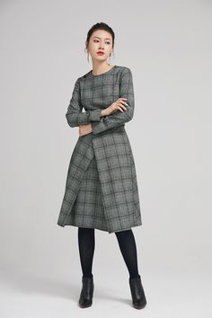 "Retro wool plaid long sleeves dress in classic hues of gray, black and white. This dress features a round neckline,fitted waist, fully lined and a back zipper closure. Details: * plaid wool fabric with fully polyester lining * long sleeves * round neckline * back zipper closure * no pockets * knee length * with buttons decoration * womens dresses, winter dress SIZE GUIDE Size vary between Brand and Country Please get your body measurement with our Size Guide And Find your size in our Size Chart Knee-length Wool Tweed Dress For Work, Wool Tweed Knee-length Dress For Work, Chic Black Long Sleeve Plaid Dress, Winter Office Wool Tweed Dress, Long Sleeve Plaid Dress For Work, Winter Wool Tweed Dress For Office, Wool Midi Dress For Work, Wool Tweed Dress For Office In Winter, Wool Long Sleeve Midi Dress For Work