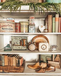 an old book shelf with books and other items on it