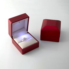 an open red box with a ring inside