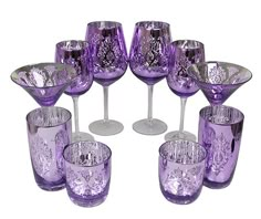 a group of purple wine glasses sitting next to each other