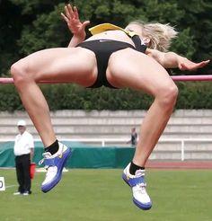 a woman jumping in the air with her legs spread