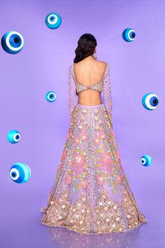 A tulle lehenga in lilac embroidered with 3D flowers, glass cut beads, sequins, evil eye beads, and plastic shells. Paired with an embroidered full sleeve georgette blouse in lilac with 3D flowers and a pink tulle dupatta.From Papa Don’t Preach’s Nazar Na Lage collection. DELIVERY TIMEPlease allow 8-12 weeks for your outfit to arrive. FABRIC DETAILSTulle, Georgette. Professional cleaning only. Purple Sets With Floral Embroidery For Reception, Party Choli With Floral Embroidery In Organza, Traditional Hand Embellished Purple Sets, Purple Floral Embroidered Set For Reception, Glamorous Embroidered Organza Sets, Festive Hand-embellished Purple Sets, Festive Hand Embellished Purple Sets, Festive Purple Hand Embellished Sets, Designer Lavender Sets With Mirror Work