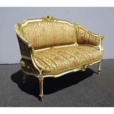 an ornately decorated couch sitting in front of a wall