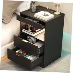 a night stand with two drawers and magazines on it's sides, next to a bed