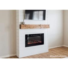 a white fireplace with a flat screen tv above it