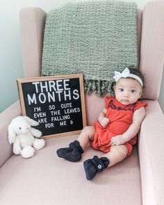 a baby sitting in a chair next to a sign that says three months i'm so cute even the ones are mine for me