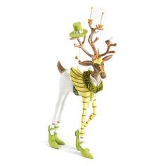 a figurine of a deer wearing green boots and a hat with candles in its mouth