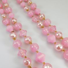 "Vintage bead necklace is a nice long length with two strands of varied shapes and sizes of pink beads. Gold filigree bead caps and tiny gold glass spacer beads. A beautiful mid-tone pink perfect for spring and summer wear. Closes with a hook closure marked \"Germany\" (I think the hook could be a replacement but it functions as it should and is as found). In very good condition. Find lots more vintage jewelry at Purple Daisy Jewelry! http://www.etsy.com/shop/purpledaisyjewelry Thanks a bunch fo Pink Single Strand Beaded Necklaces For Jewelry Making, Pink Multi-strand Necklace For Parties, Pink Beaded Double Strand Jewelry, Pink Multi-strand Faceted Beads Jewelry, Pink Double Strand Beaded Jewelry, Pink Multi-strand Jewelry With Faceted Beads, Pink Adjustable Beaded Necklaces For Costume Jewelry, Pink Double Strand Beaded Necklaces As Gift, Pink Double Strand Beaded Necklace For Gifts