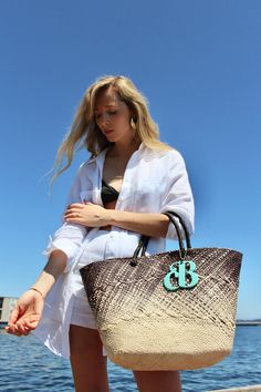 The Isla bag is an elegant basket handwoven out of the finest toquilla straw. It is made by hand in the coasts of Ecuador using a technique that is part of the UNESCO Intangible Cultural Heritage list. The ombre-dyed tote also features the signature Cuckoo B monogram in lacquered ethically-sourced buffalo horn, which is handmade in Vietnam.