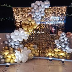 balloons and streamers are arranged in the shape of an arch for a party decoration