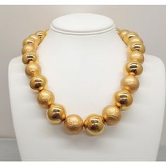 This is part of Chairish’s Costume Jewelry assortment.  Goldtone large smooth and "hammered" goldtone bead single strand necklace with hook clasp. Marked "Napier" on the hook. Dates to 1992. Interior circumference about 20 1/4 inches at the largest setting. Beads are 3/4 inches across. Overall measures: 8 inches long by 5 3/4 inches wide. Condition: Very good; light surface wear to some of the beads. The matching charm bracelet (which I'm also selling) is shown on pg. 685 of Melinda L. Lewis & H Classic Gold Necklace With Faceted Beads, Gold Necklaces With Large Beads For Formal Occasions, Formal Gold Necklaces With Large Beads, Formal Gold Necklace With Large Beads, Formal Gold Beaded Necklace With Faceted Beads, Gold Jewelry With Faceted Beads For Formal Occasions, Formal Gold Necklaces With Faceted Beads, Formal Gold Jewelry With Faceted Beads, Hook Clasp