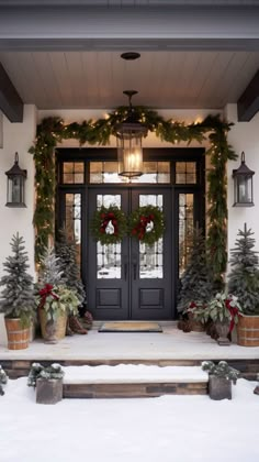 the front door is decorated for christmas with wreaths