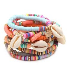 multicolored bracelets with shells and seashells are stacked on top of each other