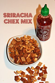 a bowl of chex mix next to a bottle of syrup